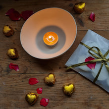 Load image into Gallery viewer, Handcrafted porcelain tealight holder with Cornish coast-inspired design, radiating a warm glow from within as it holds a tealight.
