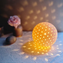 Load image into Gallery viewer, Spherical textured lamp with twinkly piercings of light. Casting warm and intricate shadow patterns.