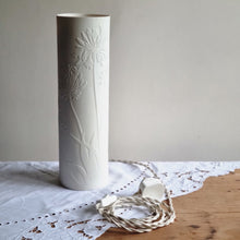 Load image into Gallery viewer, Porcelain cylinder Lamp etched with Agapanthus design in silhouette, this picture shows the switched braided cable which is cream coloured.
