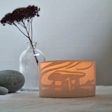 Load image into Gallery viewer, Porcelain tealight pot, crafted by Amy Cooper Ceramics, adorned with designs inspired by the mystical and ancient landmarks of Cornwall.