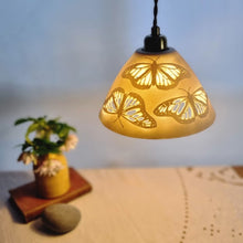Load image into Gallery viewer, Porcelain Lampshade etched with Monarch butterflies.a warm glow emitting from the patterns.