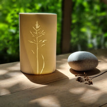 Load image into Gallery viewer, Handcrafted porcelain tealight holder inspired by the delicate textures of meadow grass, featuring intricate patterns and displayed in soft shadows.