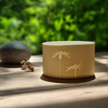 Load image into Gallery viewer, Translucent Porcelain pot with two daisies etched into it. I soft natural warm light.
