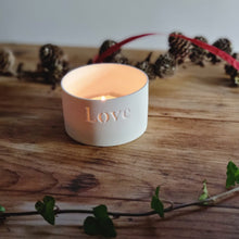 Load image into Gallery viewer, Creamy white porcelain tealight holder with the word Love etched into it.
