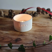 Load image into Gallery viewer, Creamy white porcelain tealight holder with the word Love etched into it.
