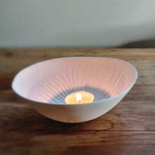 Load image into Gallery viewer, Warmly glowing handmade porcelain tealight holder inspired by Cornish coastal landscapes, designed to hold a tealight with a soft, ambient light.
