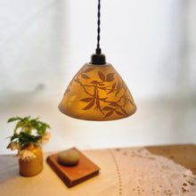 Load image into Gallery viewer, Porcelain Lampshade etched with wild roses and a butterfly. A vase with flowers, a book and a pebble in the background.