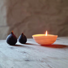 Load image into Gallery viewer, Creamy white porcelain spiral bowl glowing with a lit candle in it..