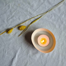 Load image into Gallery viewer, Creamy white porcelain spiral bowl with a lit tealight in it, viewed from above.