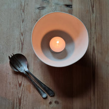 Load image into Gallery viewer, Tealight Bowl seen from above. Glowing light reflecting of the cream porcelain.