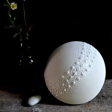 Load image into Gallery viewer, Round Lamp with textured glaze and three rows of raised bumps running across the middle. Bottle with daisies and a pebble on the left.