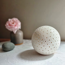 Load image into Gallery viewer, Spherical textured porcelain lamp with regular small holes all over it.
