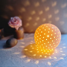 Load image into Gallery viewer, Spherical textured lamp with twinkly piercings of light.
