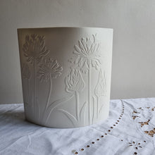 Load image into Gallery viewer, Porcelain lamp with coastal plant silhouettes designs etched onto it. Pure creamy white porcelain when unlit. Seen from above.
