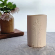Load image into Gallery viewer, Porcelain Tealight holder with single grass flower etched into it. 
