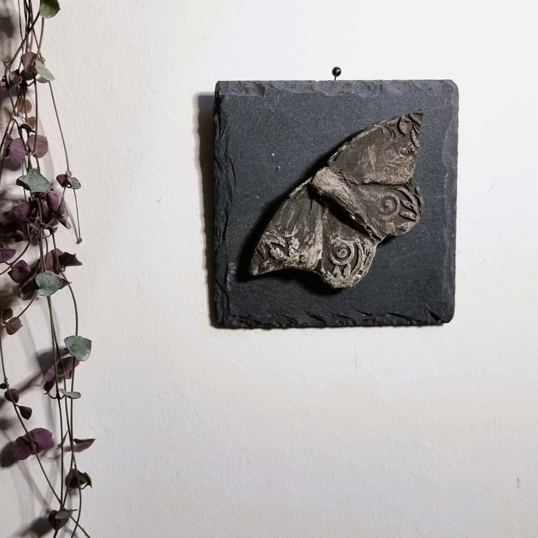 Black Stoneware Moth on slate tile to hang on the wall.