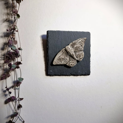 Black Stoneware Moth on slate tile to hang on the wall.