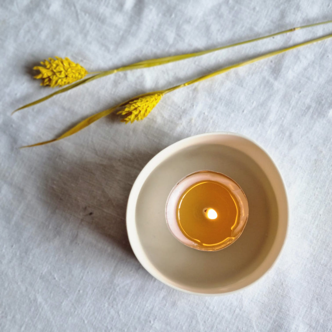 A tealight in a porcelain holder. Lifestyle photography. 