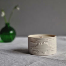 Load image into Gallery viewer, Porcelain pot filled with a poured soy wax candle. Decorated with an embossed design of St.Michaels Mount.
