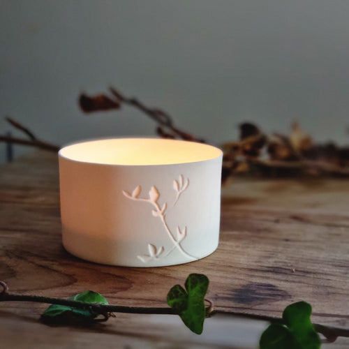 Creamy white porcelain tealight holder with Birds Foot Trefoil design etched into it.