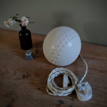 Load image into Gallery viewer, Round Lamp with textured glaze and three rows of raised bumps running across the middle. Image shows braided switched cable with UK plug.
