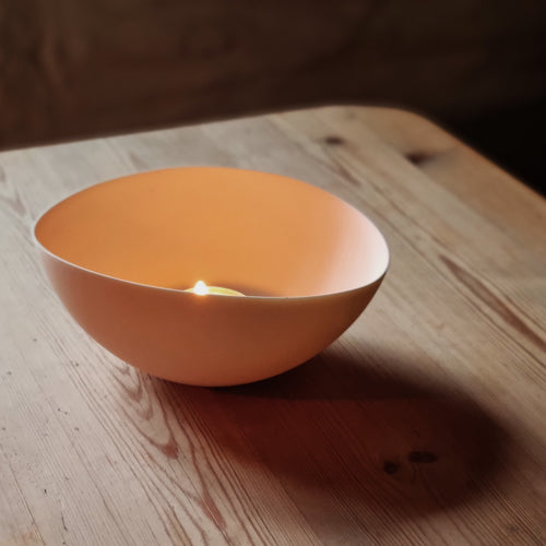 White porcelain bowl lit with tealight.