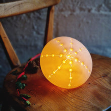 Load image into Gallery viewer, Glowing Sea Urchin Porcelain Lamp with starburst design made with indentations. casting a soft glowing light. 
