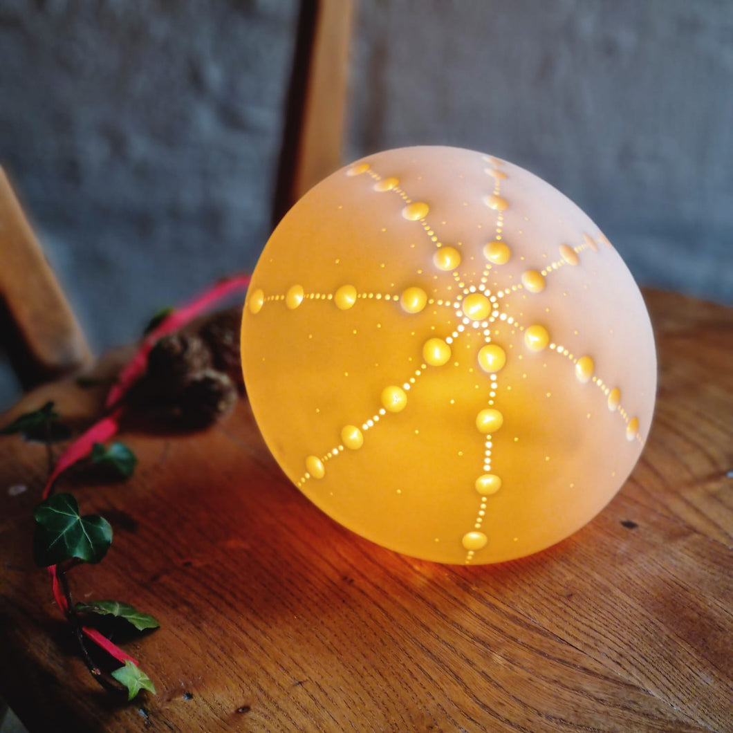 Glowing Sea Urchin Porcelain Lamp with starburst design made with indentations. 