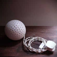 Load image into Gallery viewer, Spherical spotted porcelain lamp showing braided switched flex and UK plug.
