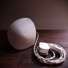 Load image into Gallery viewer, White textured asymetrical diamond shaped lamp with regularly spaced pinpricks holes., this image shows the braided switched cable with UK plug.
