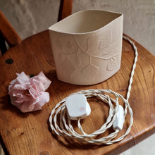 Load image into Gallery viewer, Elliptical white porcelain Lamp with Birch silhouette design etched onto it. This image shows the braided switched cable and UK plug.

