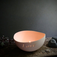 Load image into Gallery viewer, Tealight bowl inscribed with the word Love. Looking inside towards a lit candle. 
