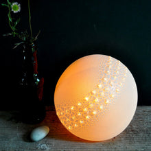 Load image into Gallery viewer, Round Lamp with textured glaze and three rows of raised sparkly bumps running across the middle. Bottle with daisies and a pebble on the left.
